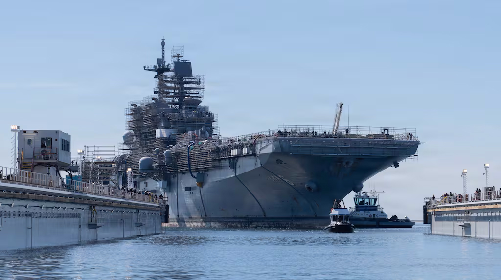 The USS America arrives at the General Dynamics National Steel and Shipbuilding Company shipyard